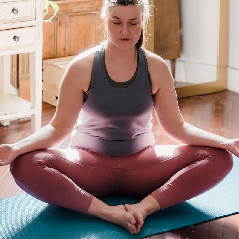 Bright and clean yoga practice space with wooden floor.